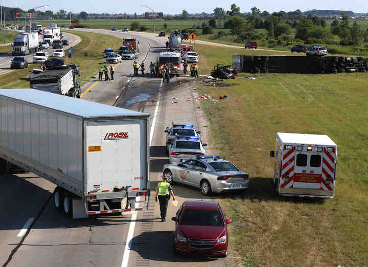 Emergency personnel work on the scene of a multi-vehicle collision involving a tractor trailer on I-280 near Walbridge Road in Lake Township.  (Kurt Steiss / The Blade)